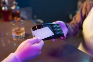 high angle adult paying with card