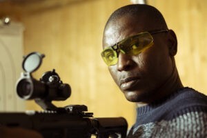 person practicing with rifle wearing safety goggles