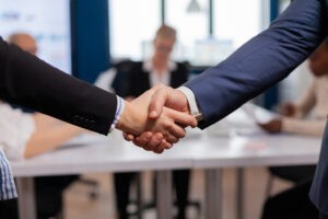 satisfied businessman company employer wearing suit handshake new employee get hired job interview man hr manager employ successful candidate shake hand business meeting placement concept